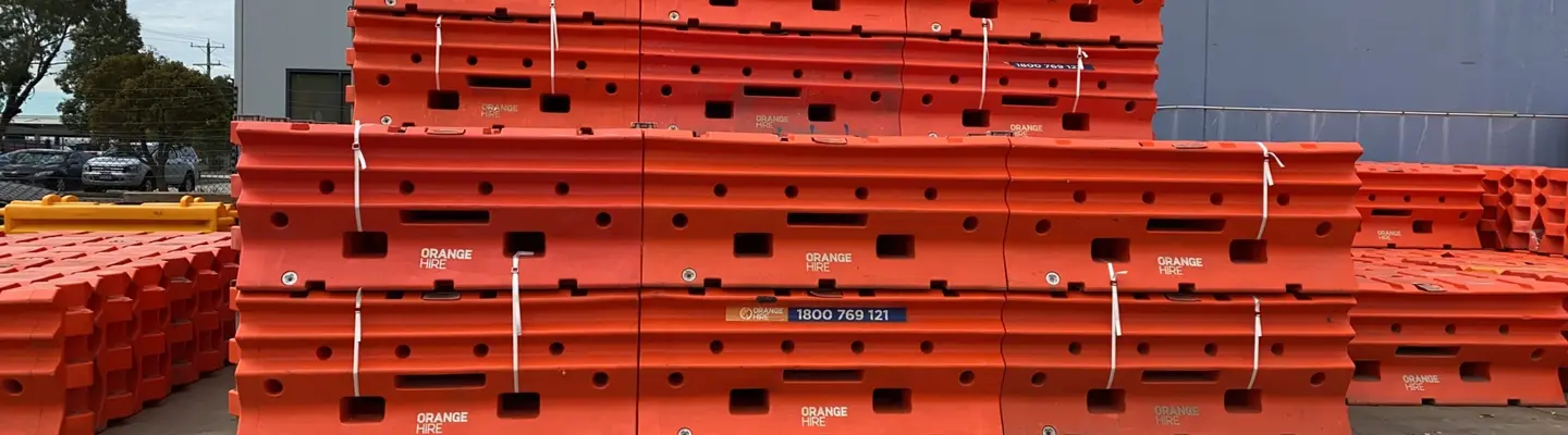 Stockpile of construction materials neatly arranged on-site, ready for use, with safety barriers and labels in place.