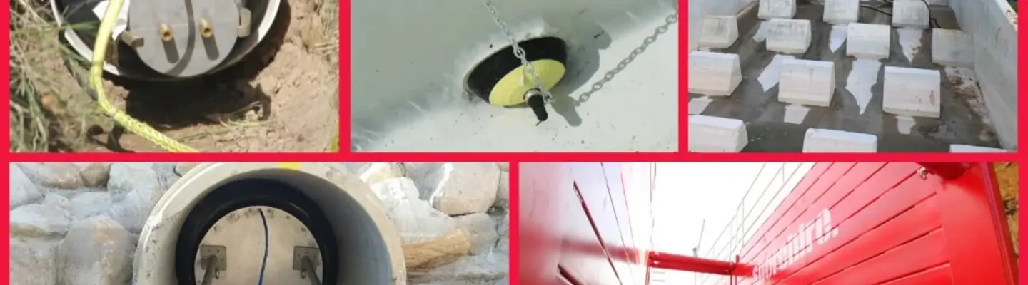 Excavation site showing a hole with visible pipe plugs, surrounded by safety cones and construction barriers.