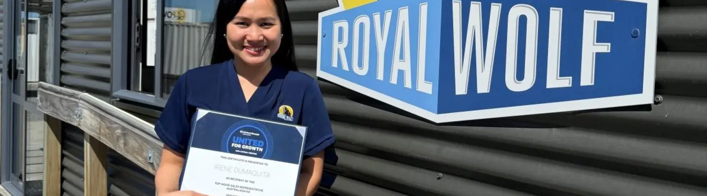 Sales representative receiving a Top Sales award certificate during a recognition ceremony.