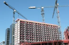 cranes in front of building