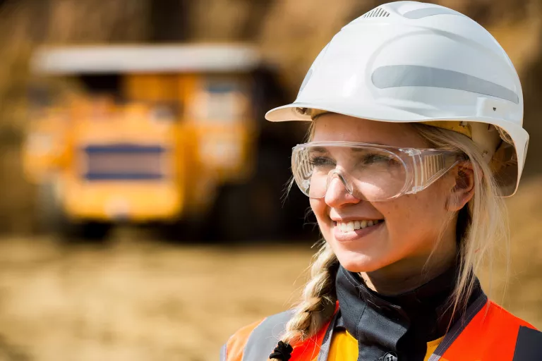 Female employee wearing hardhat PPE