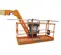 Front view of an orange JLG lift basket with guardrails and an extended boom arm.