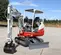 Red and white Takeuchi Mini Excavator with Reduced Tail Swing
