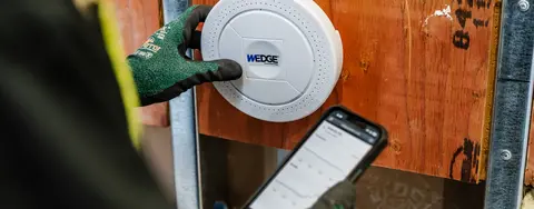 A wedge appliance being ulitized by a worker on a worksite.