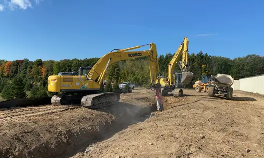 Excavator digging a trench