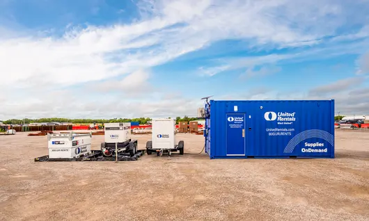 Blue Cargo Container with White Generators on Worksite