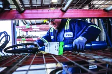 construction worker picking up tool