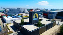 Shipping container converted into a heritage exhibit room in a museum, showcasing historical artifacts and informational displays.