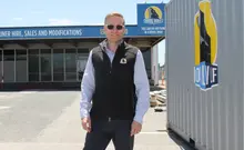 Company manager standing in front of the company building, overseeing operations related to construction safety and barrier solutions.