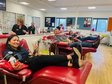 Company staff members participating in a blood donation drive, highlighting employee involvement in community health efforts.